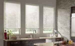 White 2” faux wood blinds in kitchen with dark cabinets
