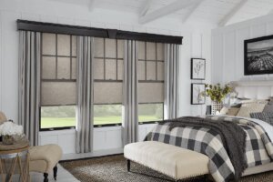 Grey drapes in a bedroom complete with cellular shades birmingham